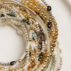 Close-up of multiple beaded bracelets on a white plate